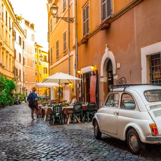 Rome, Italy - May 28, 2017: Cozy street in Trastevere, Rome, Europe. Trastevere is a romantic district of Rome, along the Tiber in Rome. Turistic attraction of Rome.