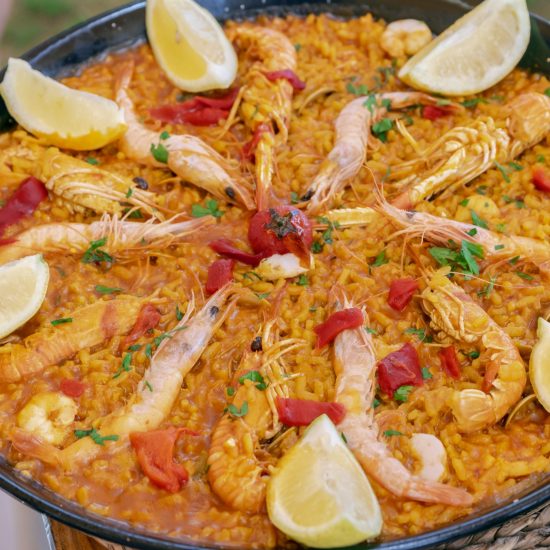 SEAFOOD PAELLA IN A TRADITIONAL PAN. TYPICAL SPANISH FOOD. SELECTIVE FOCUS. TOP VIEW.
